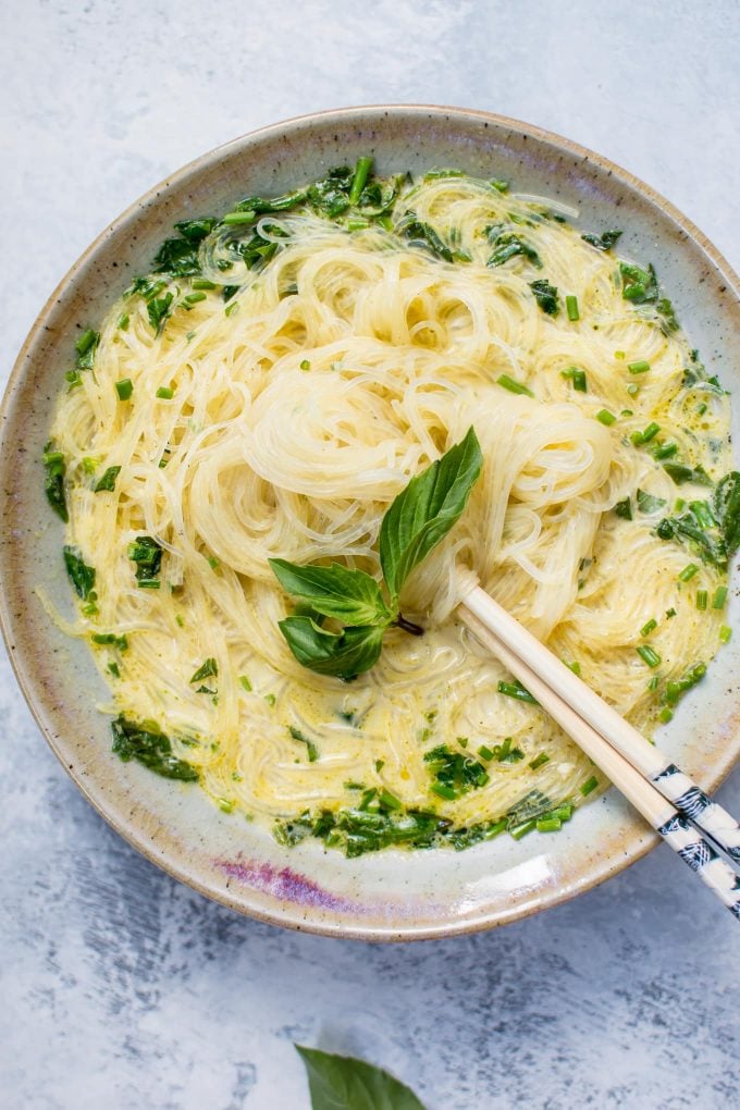 vegan Thai green curry soup in a bowl with chopsticks