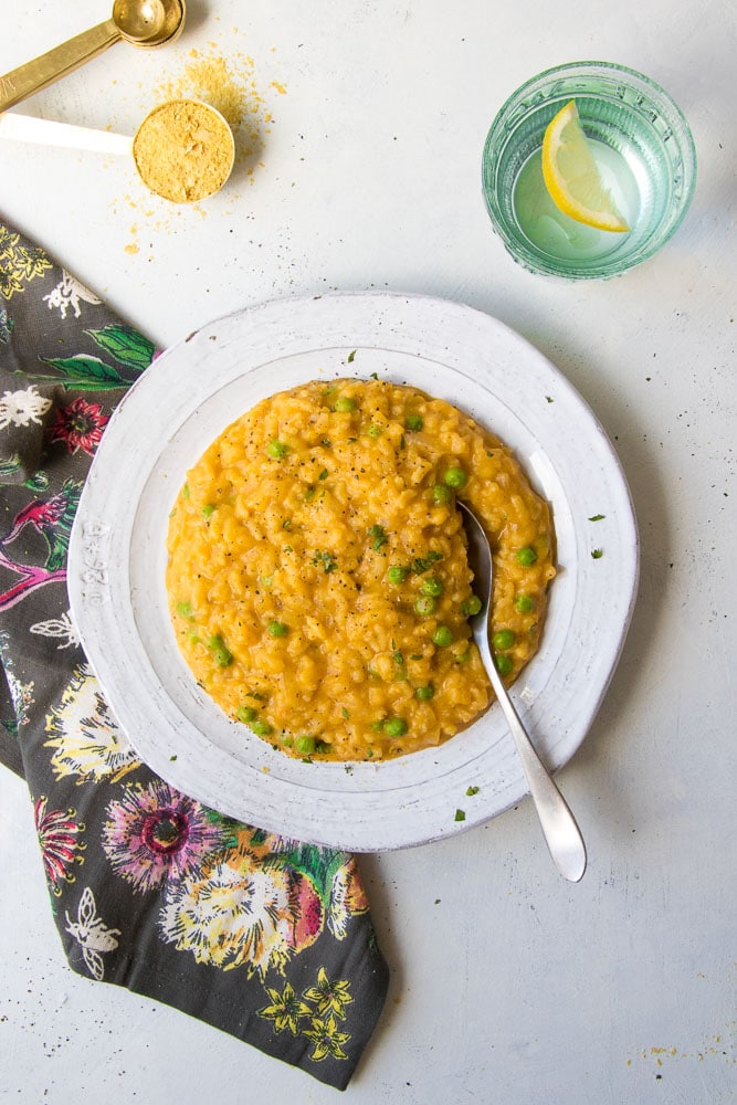 pumpkin risotto in a white bowl with a spoon