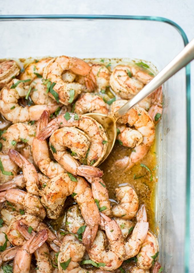 chili lime shrimp in a baking dish with serving spoon