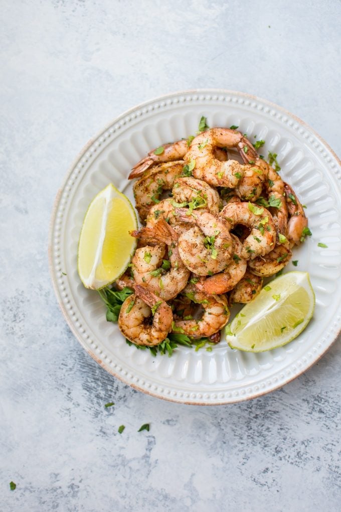 bowl of baked chili lime shrimp with lime garnish