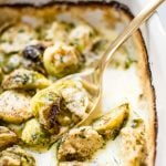 These creamy baked Brussels sprouts with garlic, parmesan, and a touch of brandy make an easy and decadent side dish that's tasty enough for a special occasion.