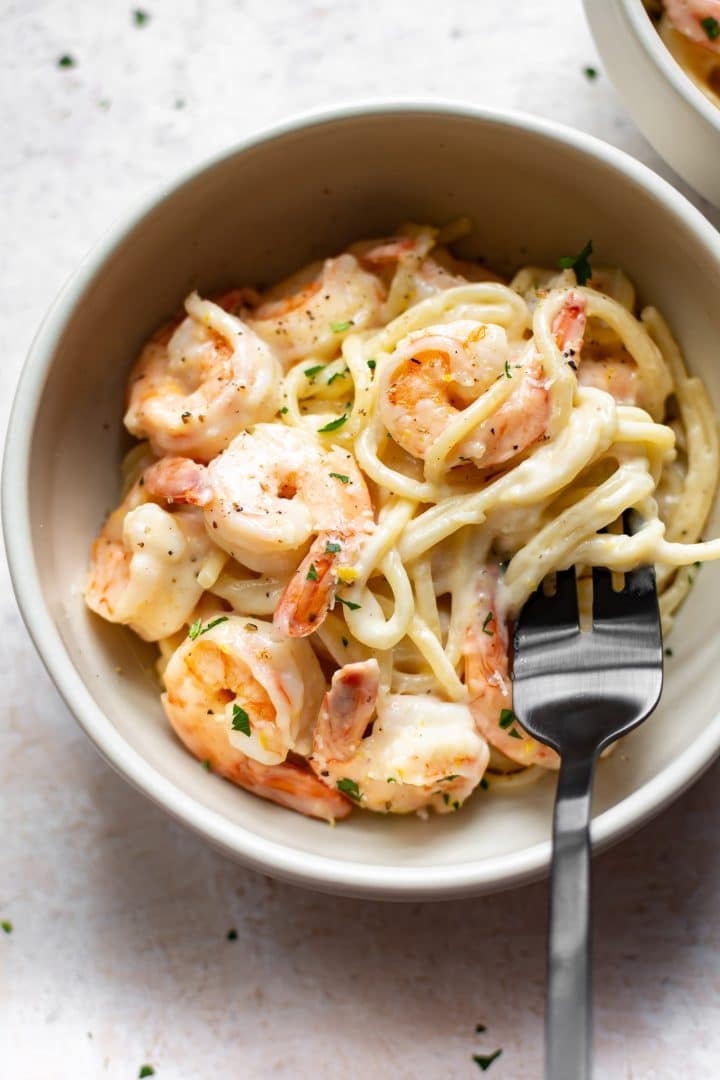 creamy lemon shrimp pasta with a fork twirling the spaghetti