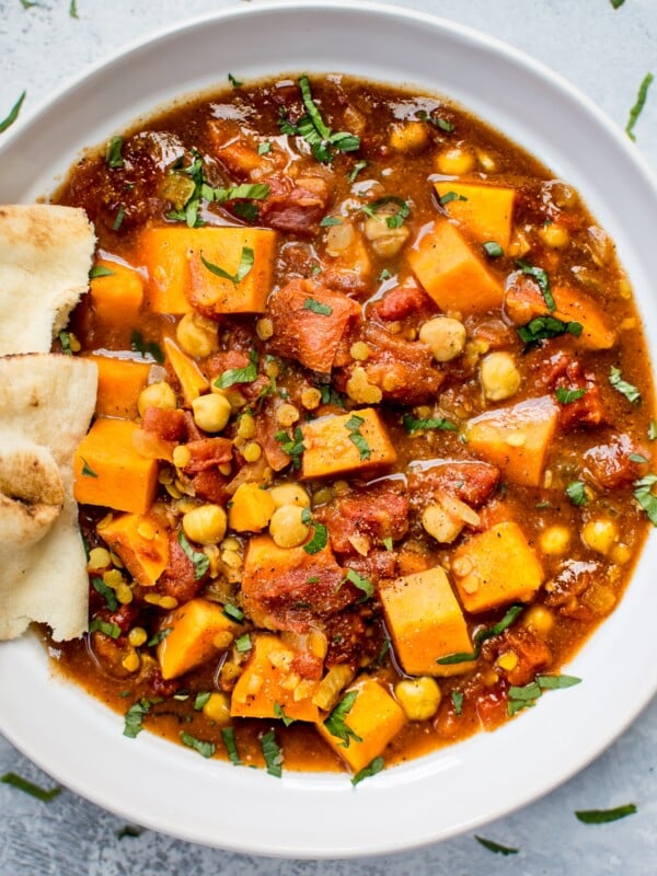 This Crockpot sweet potato curry is loaded with good stuff including red lentils, chickpeas, oodles of sweet potatoes, and a vibrant blend of spices. This is the best vegan stew I've ever made!