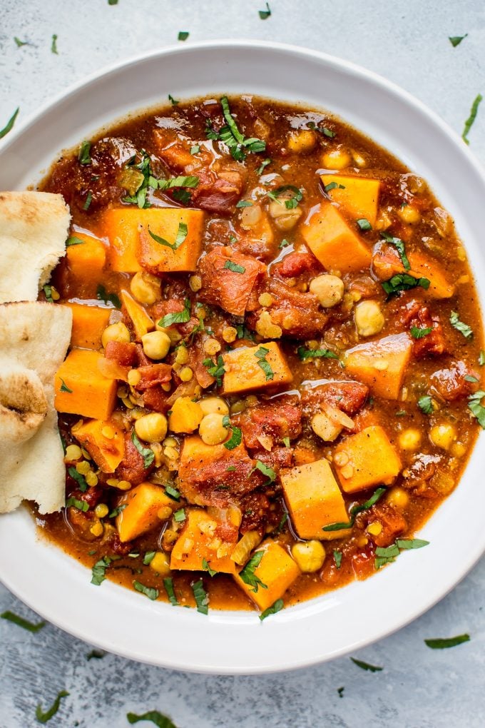 close-up of crockpot vegan sweet potato curry in a white bowl