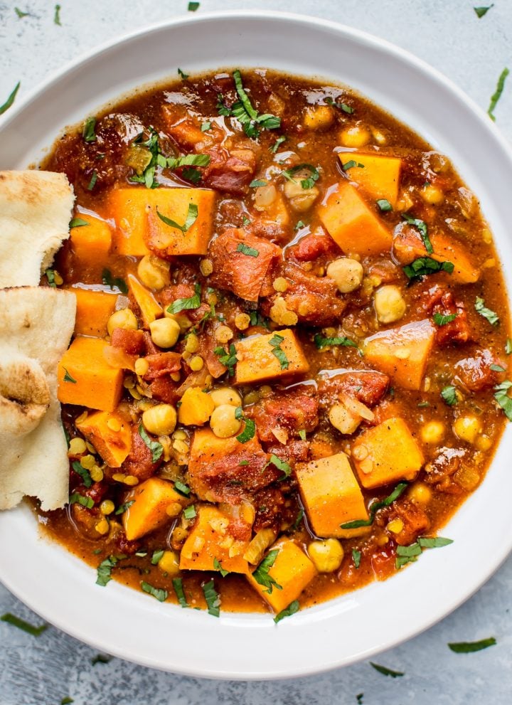 This Crockpot sweet potato curry is loaded with good stuff including red lentils, chickpeas, oodles of sweet potatoes, and a vibrant blend of spices. This is the best vegan stew I've ever made!