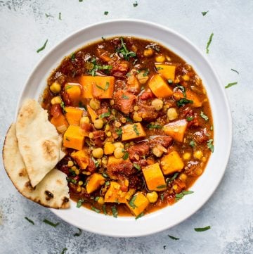This Crockpot sweet potato curry is loaded with good stuff including red lentils, chickpeas, oodles of sweet potatoes, and a vibrant blend of spices. This is the best vegan stew I've ever made!