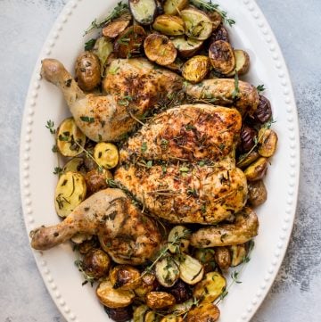 This easy spatchcock chicken recipe includes little potatoes that are roasted alongside the chicken on the same baking sheet. A crowd-pleasing sheet pan dinner recipe that's faster than your typical roast chicken.