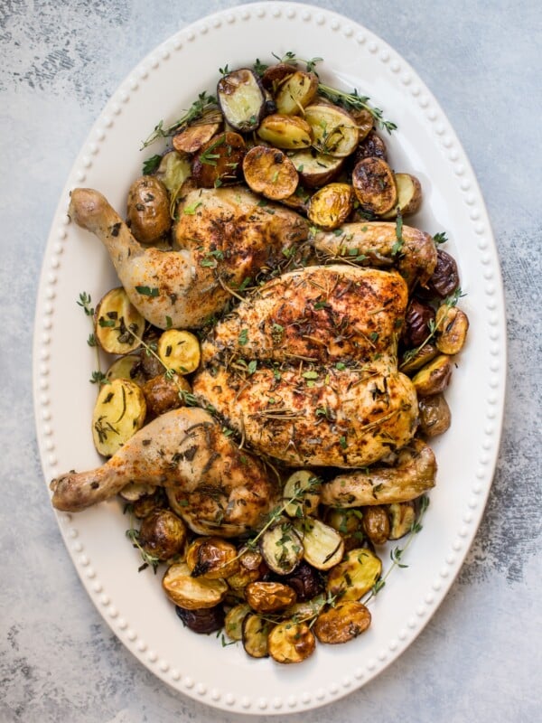 This easy spatchcock chicken recipe includes little potatoes that are roasted alongside the chicken on the same baking sheet. A crowd-pleasing sheet pan dinner recipe that's faster than your typical roast chicken.