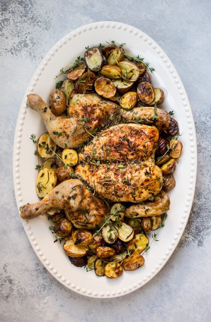 oval serving platter with spatchcock chicken and potatoes