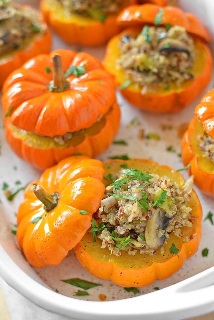 several mushroom quinoa stuffed mini pumpkins in a white casserole dish