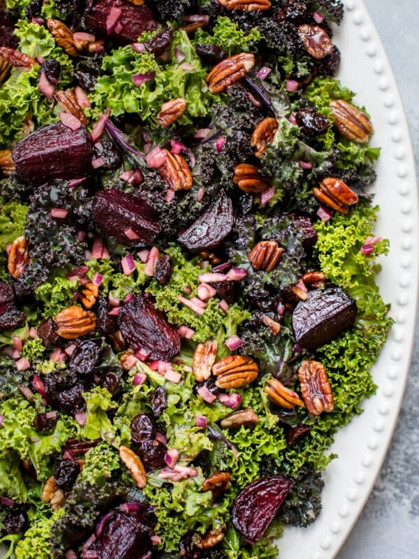 This kale and beet salad is a healthy vegetarian fall salad with dried cranberries, pecans, and a tangy balsamic vinaigrette dressing.