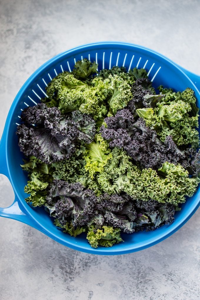 blue colander with fresh kale