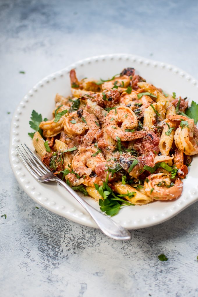 bowl of spicy shrimp pasta with a roasted tomato sauce
