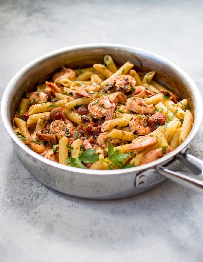 metal skillet with spicy shrimp pasta