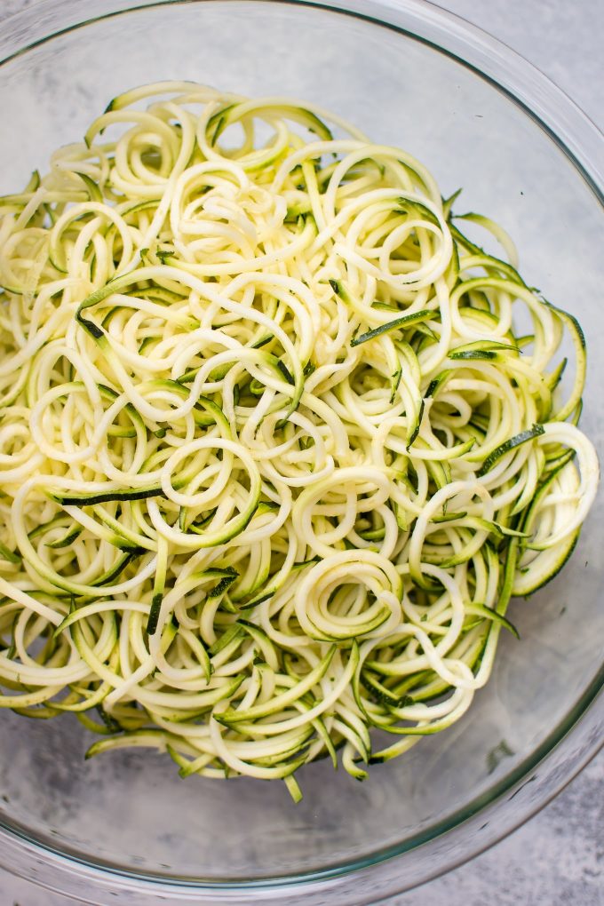 glass bowl of raw zucchini noodles