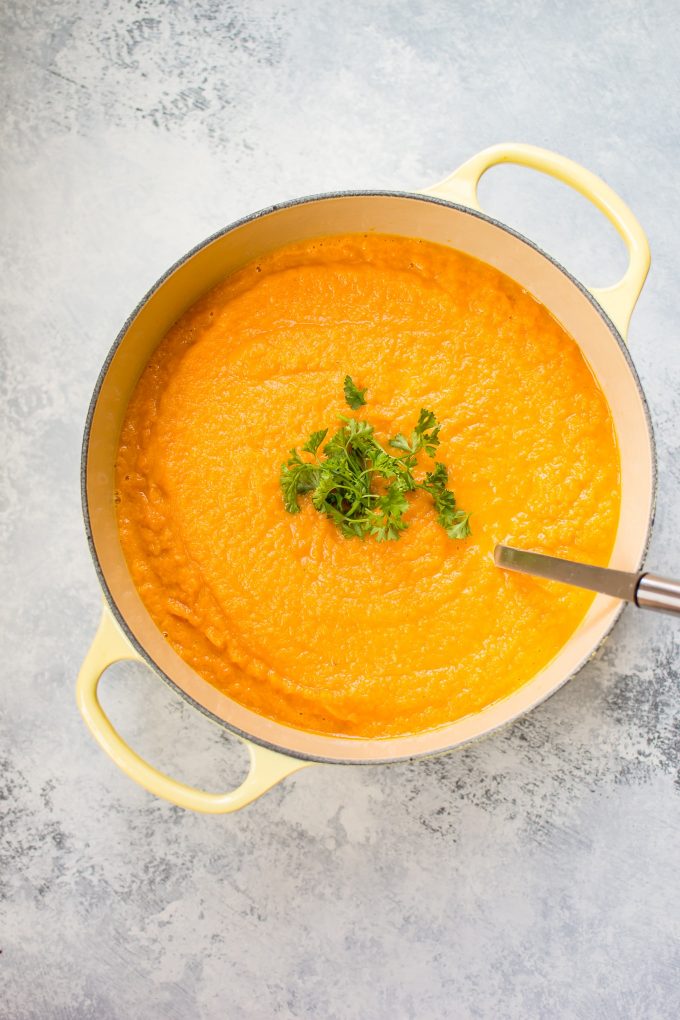 yellow pot with carrot celeriac soup with ladle