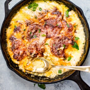 These cheesy scalloped sweet potatoes are the ULTIMATE comfort food side dish. Gruyère, Parmesan, cream, garlic, and seasonal spices bake to melty perfection. No one will be able to resist this side dish.