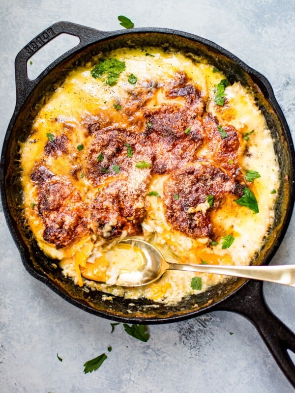 These cheesy scalloped sweet potatoes are the ULTIMATE comfort food side dish. Gruyère, Parmesan, cream, garlic, and seasonal spices bake to melty perfection. No one will be able to resist this side dish.