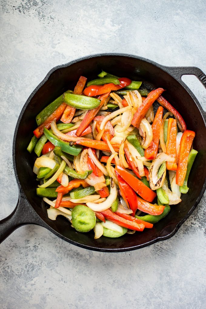 cast iron skillet with vegetables for low-carb chicken fajita bowls