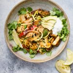 These chicken fajita zoodle bowls are a low-carb way to get your fajita fix! Topped with avocado, Greek yogurt, and fresh cilantro, they make a light and tasty meal. 