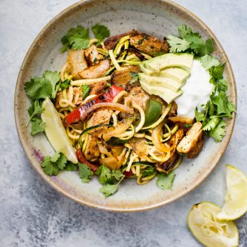 These chicken fajita zoodle bowls are a low-carb way to get your fajita fix! Topped with avocado, Greek yogurt, and fresh cilantro, they make a light and tasty meal.