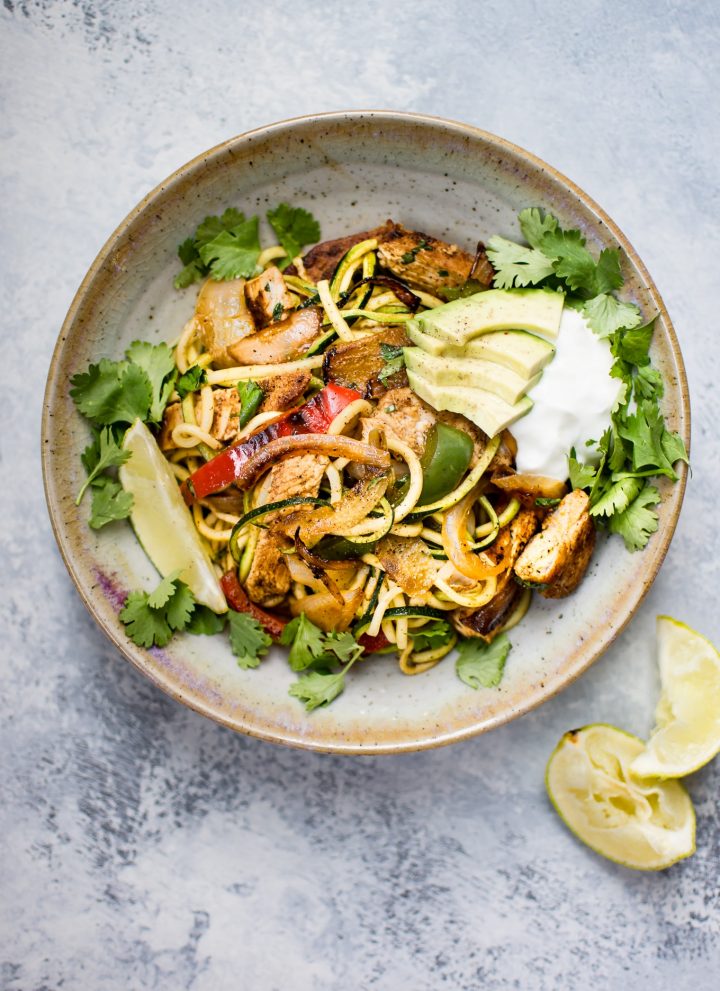 These chicken fajita zoodle bowls are a low-carb way to get your fajita fix! Topped with avocado, Greek yogurt, and fresh cilantro, they make a light and tasty meal. 