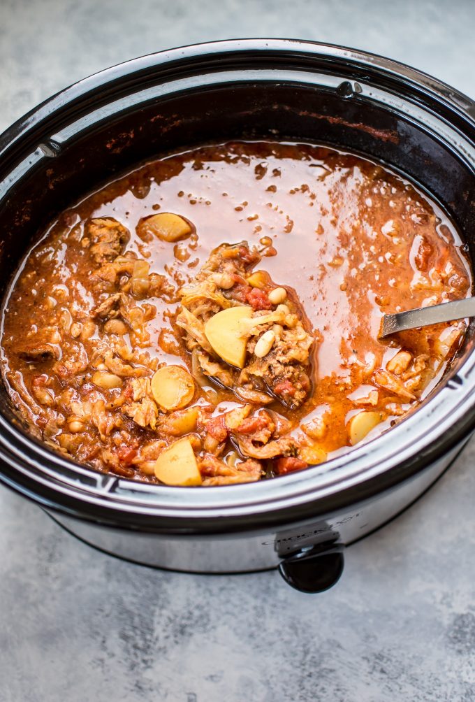 cabbage soup with sausage in a slow cooker with ladle