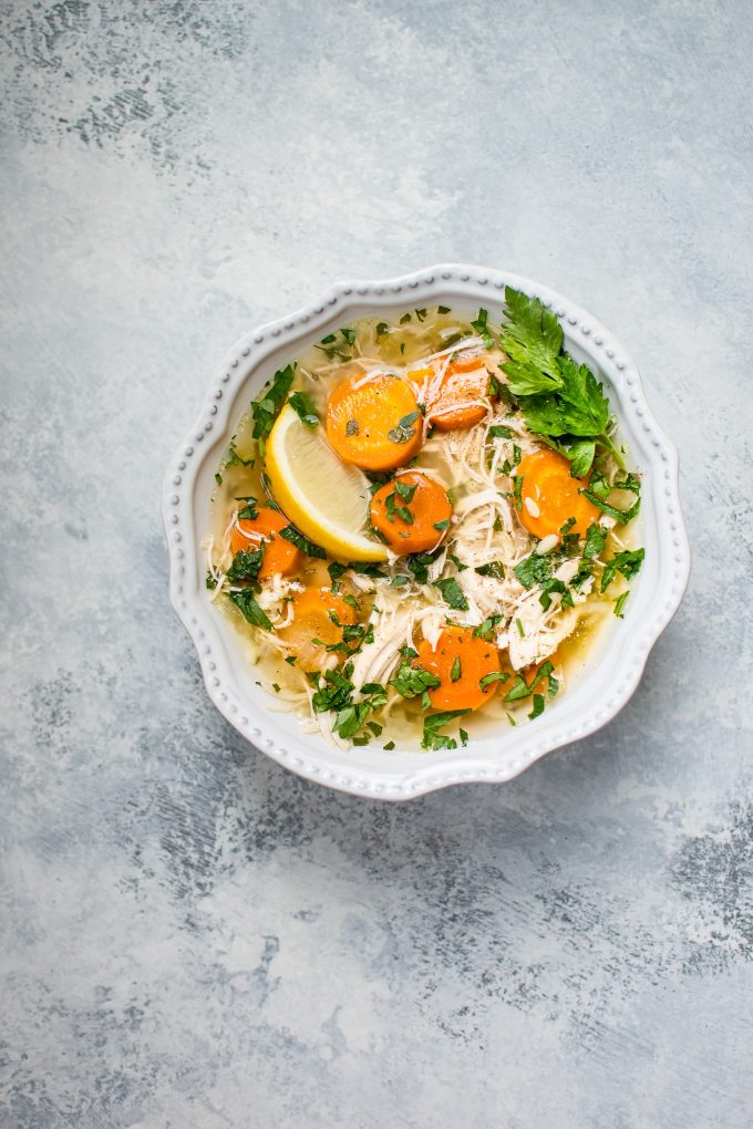 bowl of healthy lemon chicken orzo soup with carrots
