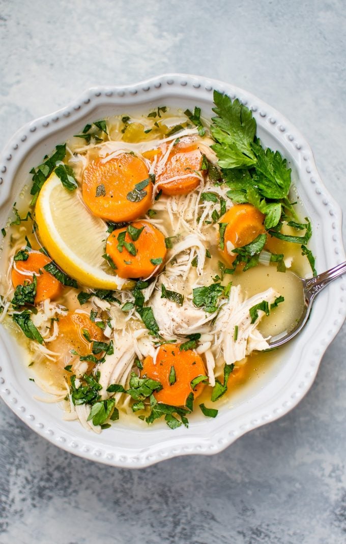 close-up of lemon chicken orzo soup in a bowl with a spoon