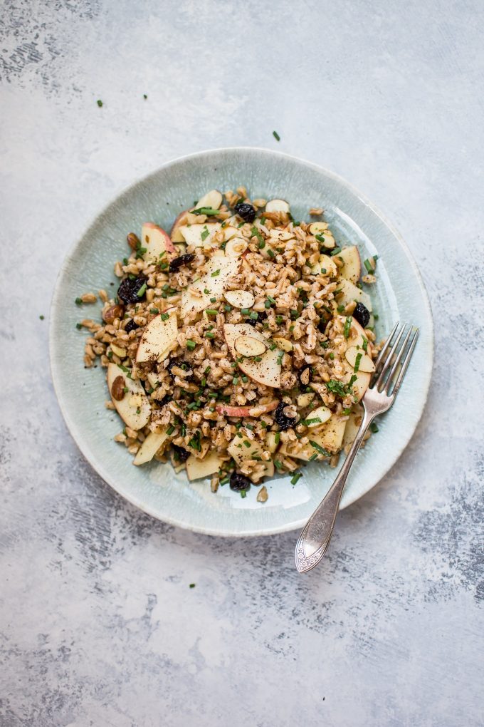 teal plate with vegan farro salad and a fork