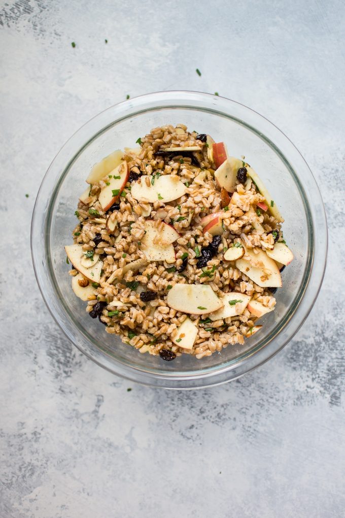 glass bowl with fall farro salad with apple slices