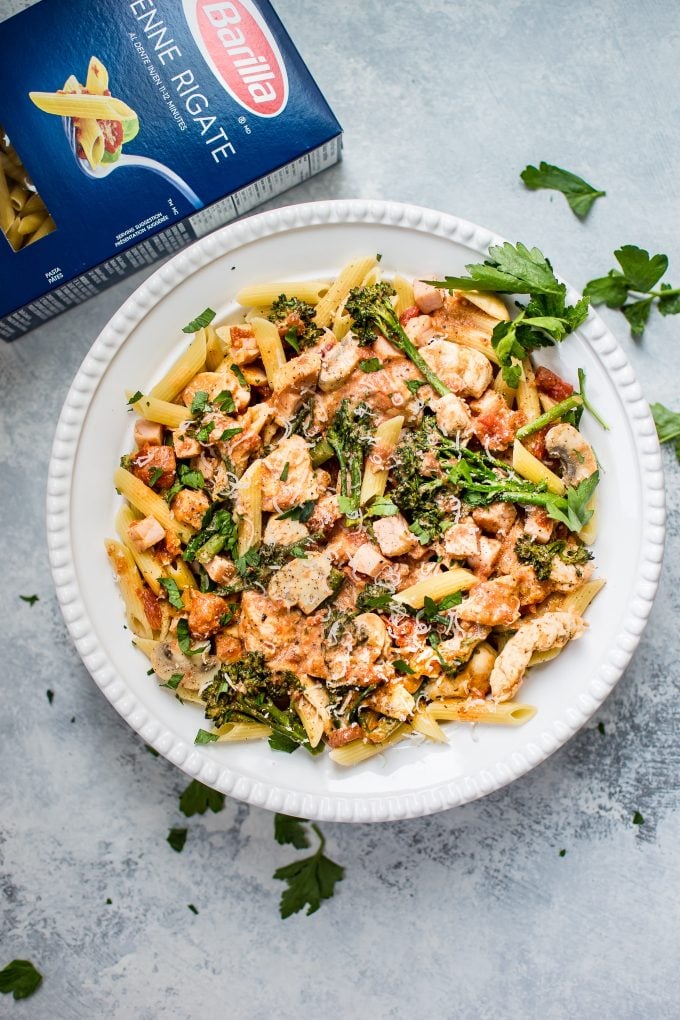 chicken and bacon pasta in a bowl beside box of Barilla pasta
