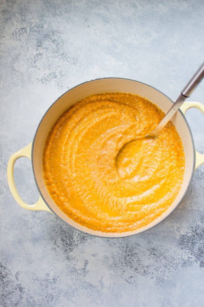 yellow pot with pumpkin lentil soup and ladle