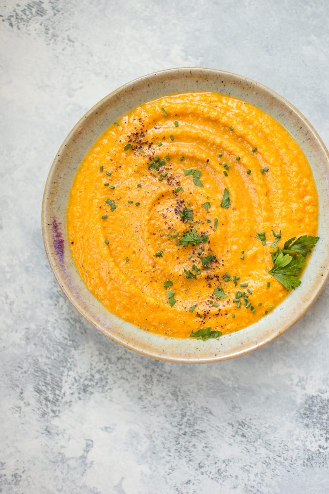 earthenware bowl of vegan pumpkin and red lentil soup