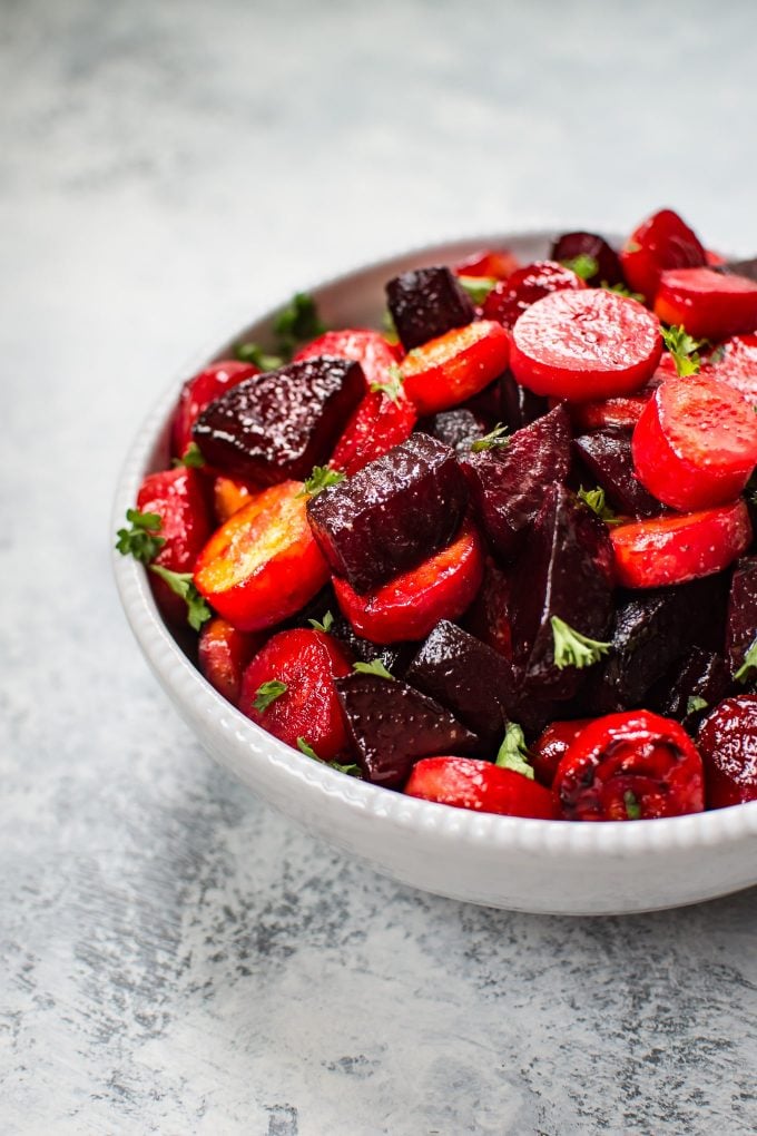 bowl of roasted beets and carrots topped with parsley
