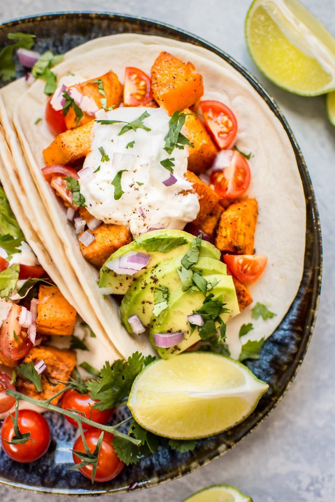 close-up of roasted sweet potato taco beside lime wedge