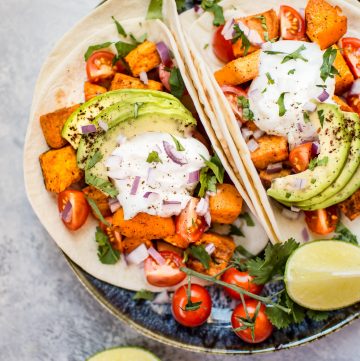 This roasted sweet potato tacos recipe makes a delicious, filling, and nutritious meat-free meal! Load 'em up with your favorite toppings and enjoy these all season long.