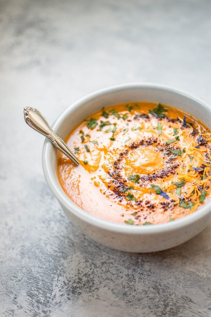 bowl of spicy sweet potato soup with a spoon