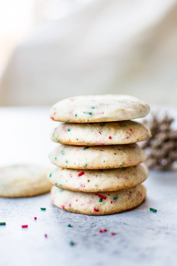 stack of five vegan sugar cookies with red and green sprinkles