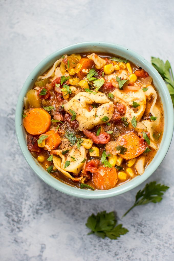 teal bowl with vegetarian tortellini vegetable soup