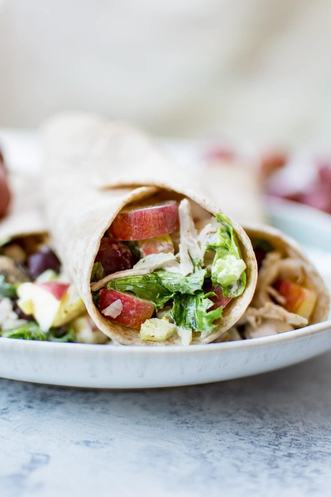 three Waldorf chicken salad wraps on a plate