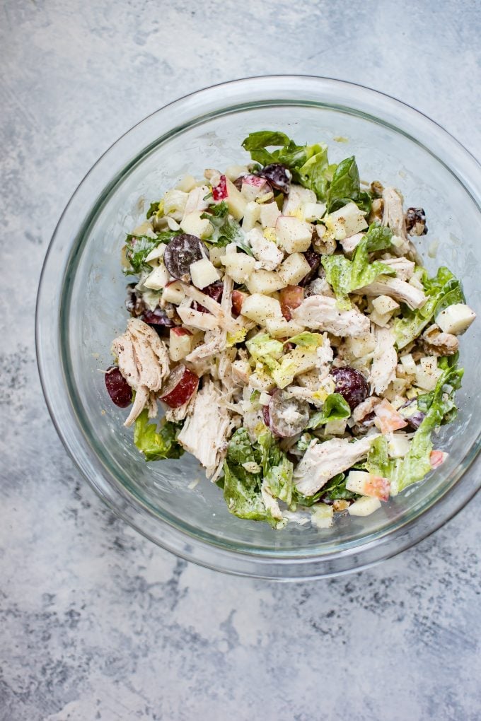 glass bowl with ingredients for Waldorf chicken salad wraps