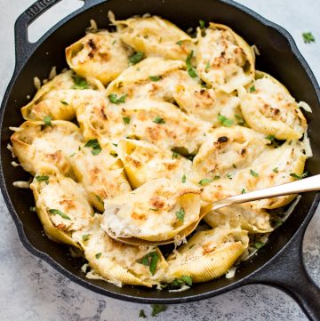 This lemon chicken stuffed shells recipe is easy, cheesy, and delicious. Three different kinds of cheeses and flavorful lemon chicken are baked to melty perfection. This recipe makes an awesome comfort food dinner!