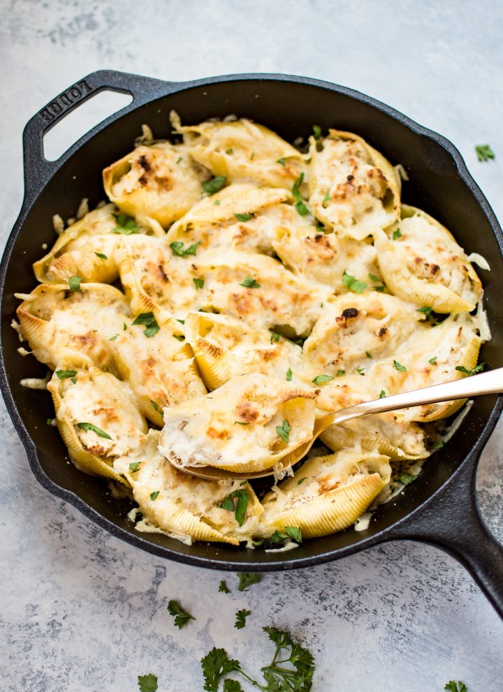 This lemon chicken stuffed shells recipe is easy, cheesy, and delicious. Three different kinds of cheeses and flavorful lemon chicken are baked to melty perfection. This recipe makes an awesome comfort food dinner!