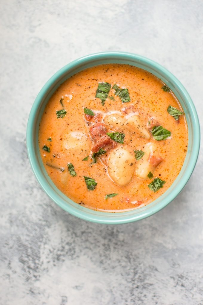 bowl of creamy gnocchi tomato soup on a marble surface