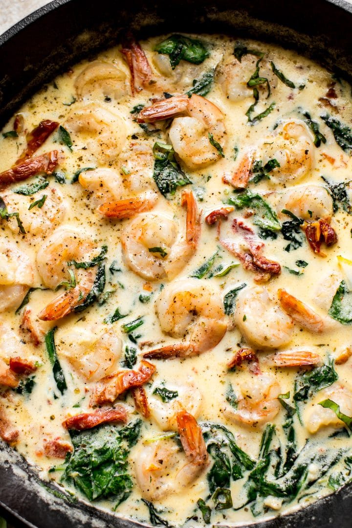 Creamy garlic butter Tuscan shrimp - a quick and easy weeknight dinner! Great served with pasta or mashed potatoes.