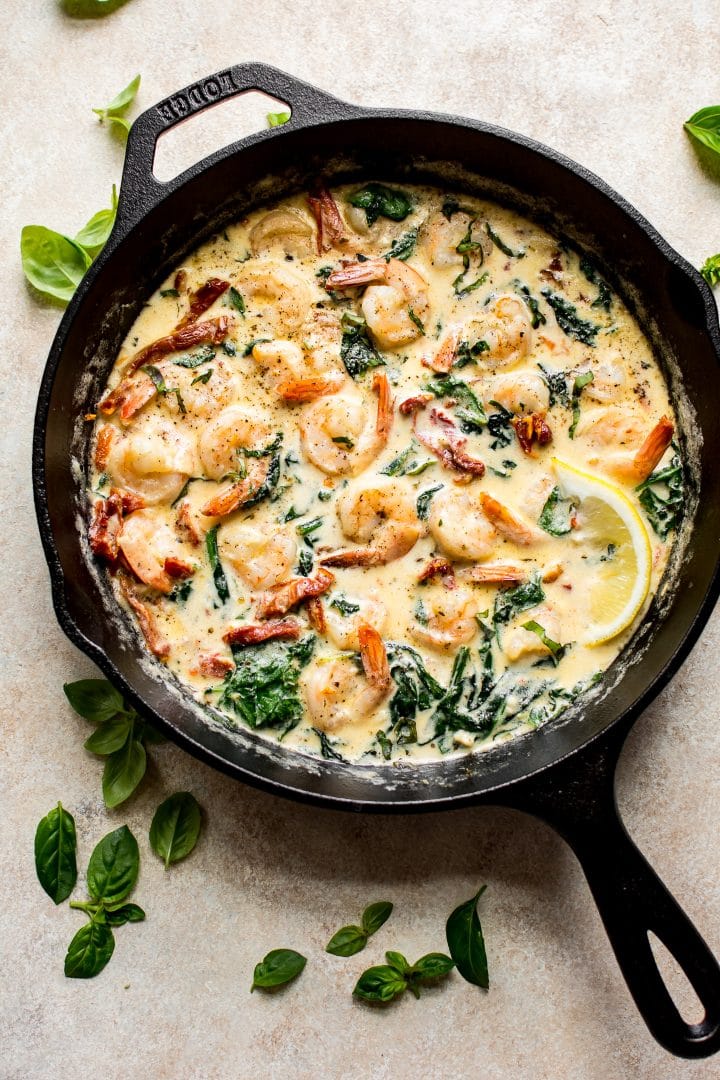 Make this creamy Tuscan shrimp recipe for dinner tonight - you will love the garlicky sun-dried tomato, basil, and spinach sauce!