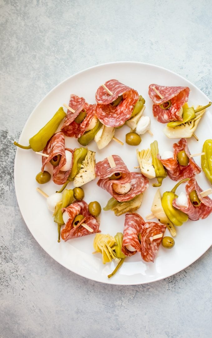 several easy antipasto skewers on a white plate