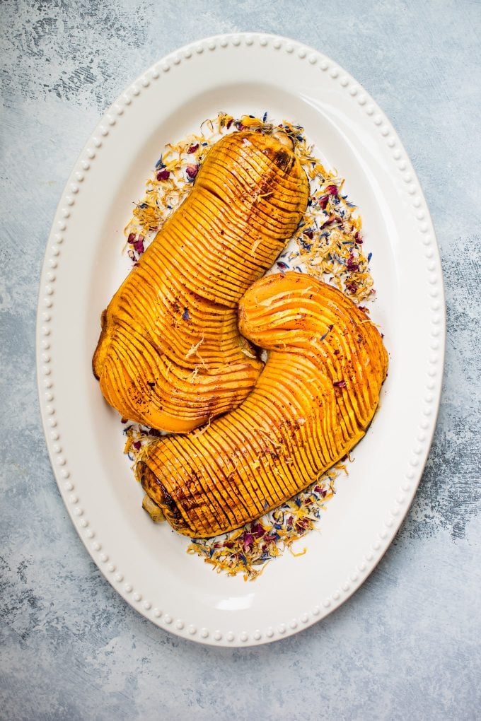 hasselback butternut squash on an oval serving plate