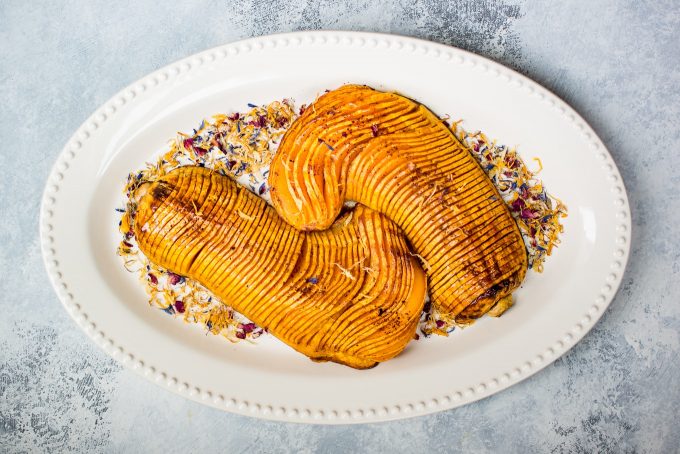 honey cinnamon roasted butternut squash on an oval serving platter